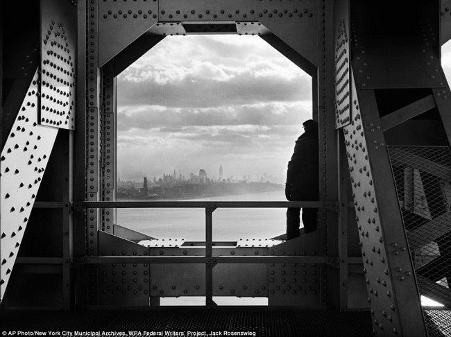 The view from New Jersey: A man across the Hudson River from his perch on the George Washington Bridge on December 22, 1936