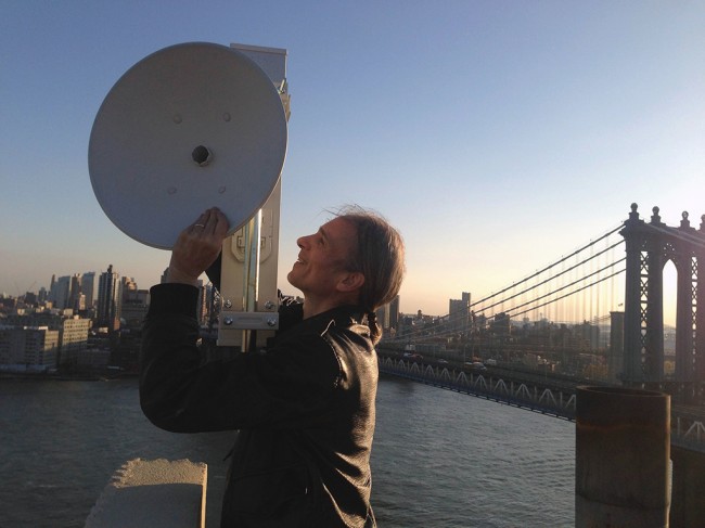 Paul Garrin installs a WiFi-NY antennae at 82 Rutgers Slip; the installation is slated to be up and running by early 2015. | Photo courtesy of Two Bridges